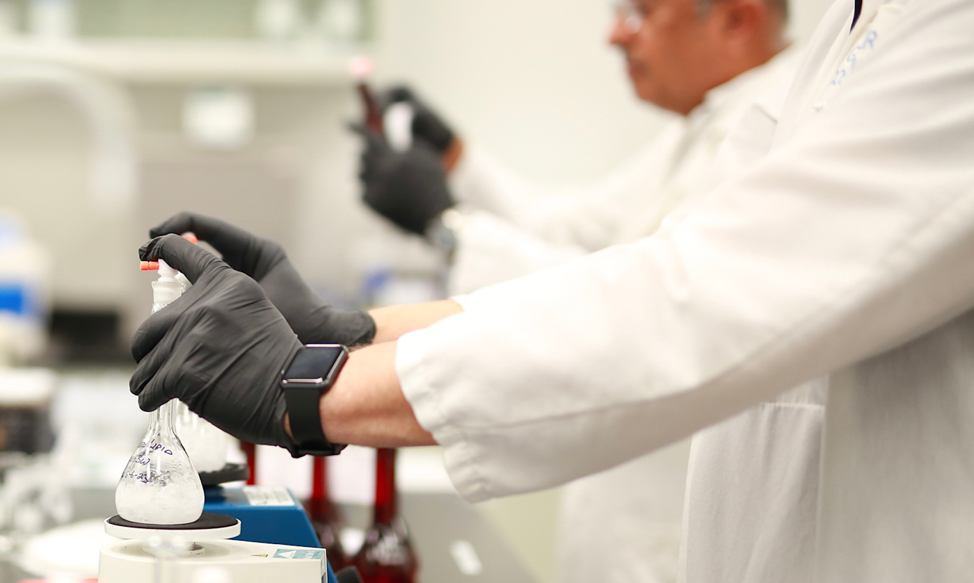 Scientist evaluating formulation under controlled lighting